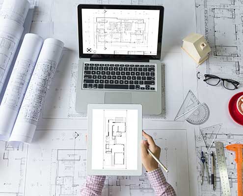 architecture-it-services-architect-desk-blueprints.jpg